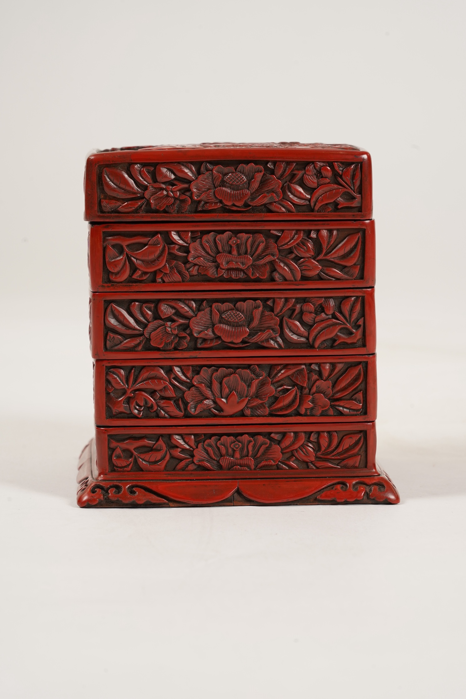 A Chinese Ming cinnabar lacquer four tier box, 15th century